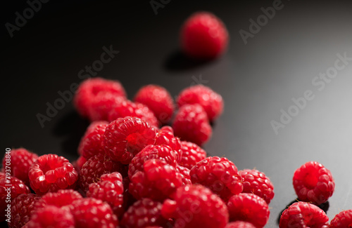 Raspberry fresh berries closeup, ripe fresh organic Raspberries over black background, macro shot. Harvest concept