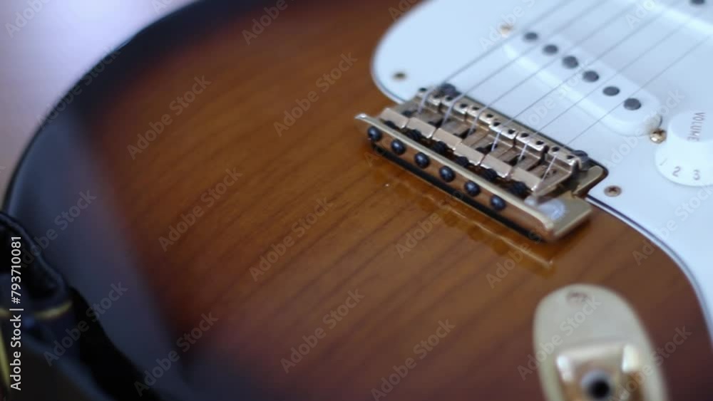 Pan over close up of guitar body Pan over close up of guitar body