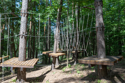 Rope park. Rope ladders. Summer activity. Sport. Children's playground in nature in the forest.