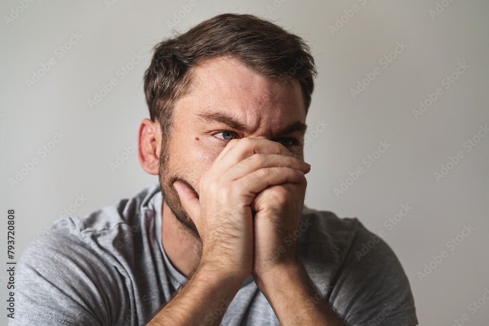 Stressed man covers his face with his hands closeup portrait. Mental illness and depression. Stressed man covers his face with his hands closeup portrait. Mental illness and depression.
