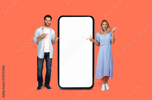 Man and woman presenting a large smartphone