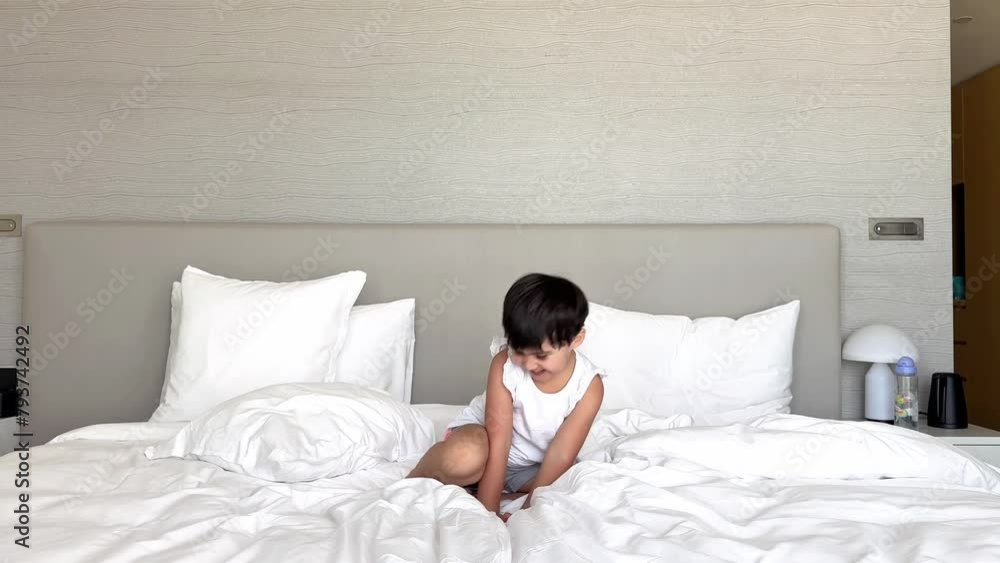 Authentic slow motion shot of little girl s in white pajamas are having fun to jump on the bed in the bedroom. High quality 4k footage Authentic slow motion shot of little girl s in white pajamas are having fun to jump on the bed in the bedroom. High quality 4k footage