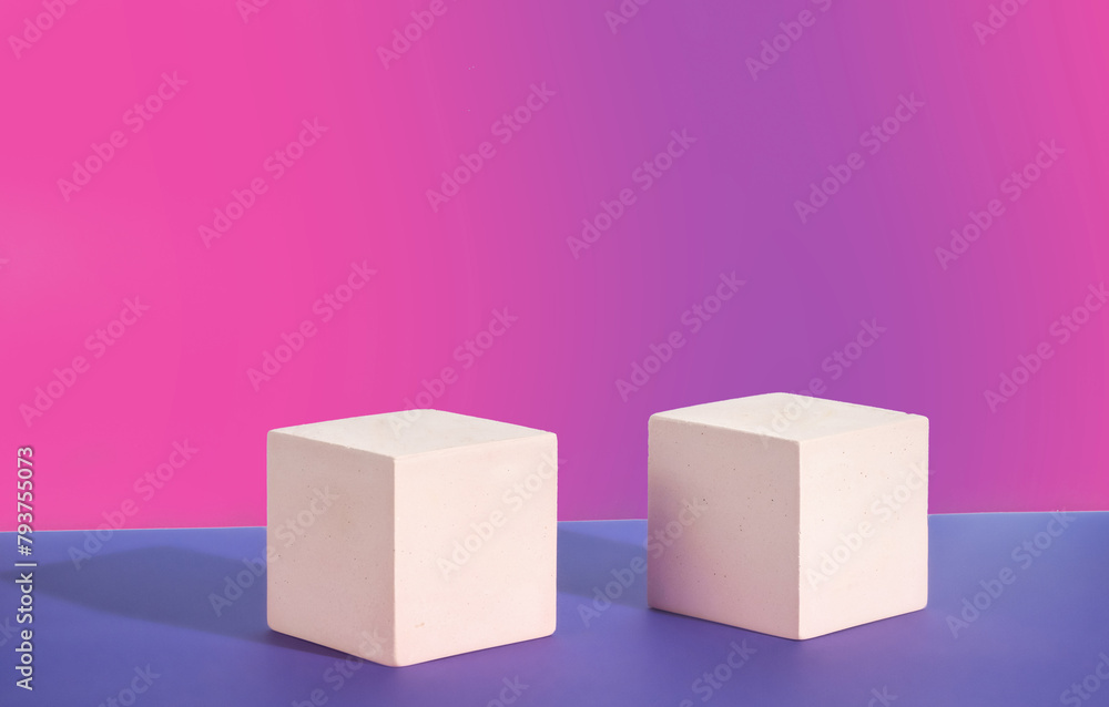 Two pink cement cubic display on a pink gradient background. Mockup for the demonstration of cosmetic products Two pink cement cubic display on a pink gradient background. Mockup for the demonstration of cosmetic products
