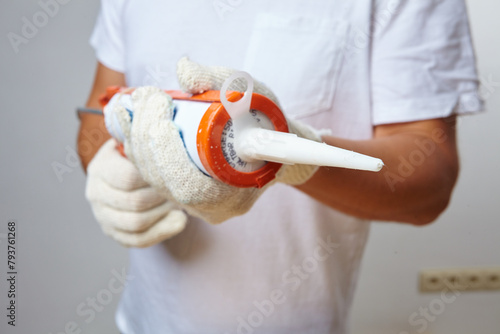 man with glue in white gloves photo