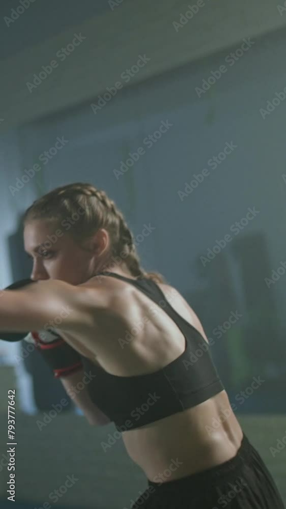 Training battle of two woman fighters, training in the boxing gym, fighter train defense and series of punches, vertical video. Training battle of two woman fighters, training in the boxing gym, fighter train defense and series of punches, vertical video.