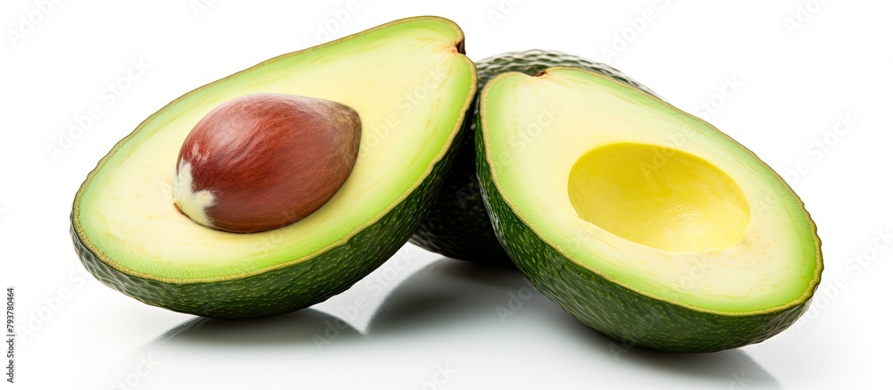 Half of avocado with seed and halves cut Half of avocado with seed and halves cut