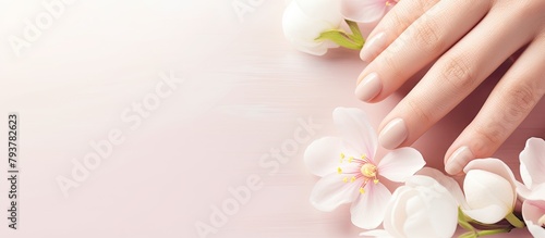Hand with manicured nail and flowers