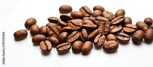 A close-up of a heap of roasted coffee beans on a bright surface