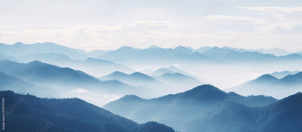 Mountains with scattered clouds in the serene sky