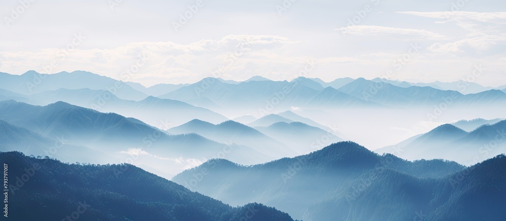 Mountains with scattered clouds in the serene sky Mountains with scattered clouds in the serene sky