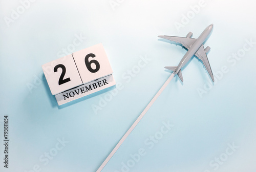 November calendar with number  26. Top view of a calendar with a flying passenger plane. Scheduler. Travel concept. Copy space.