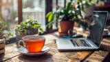 AI generated illustration of a laptop, tea cup, and plants on a table