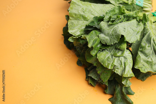 Chinese Kale or Kailaan or Hong Kong Kale Isolated on Yellow Background.  photo