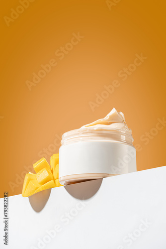 Packaging for cosmetics pump bottles without logo and label. A bottle of mango-scented body cream