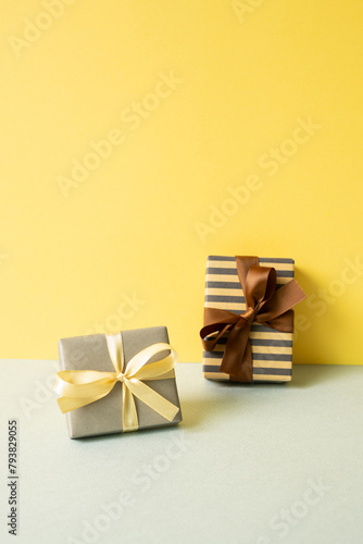 Gift boxes on gray table. yellow wall background