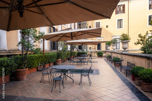 Details from the sumptuous and rich exterior of the Palazzo Colonna in Rome, Italy. Beautifully furnished and cosy place for rest and coffee with lots of plants.