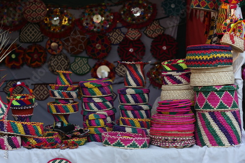 Stack of traditional Plates and handmade ceramics, handmade colorful dishes , Handicraft kettle item, Colorful Handmade Pottery and Ceramics, Souvenir Shop in lok virsa mela Islamabad 