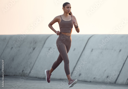 Fitness, running and girl in outdoor workout in body health, energy or wellness on promenade. Exercise, commitment and woman runner with dedication to morning marathon training, performance or cardio