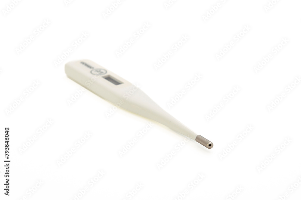 White digital thermometer isolated on white background with copy space. Close-up, selective focus. White digital thermometer isolated on white background with copy space. Close-up, selective focus.