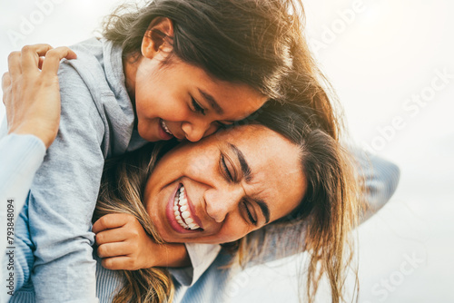 Happy latin mother and daughter having fun outdoor - Love, family and mum day concept - Main focus on woman face
