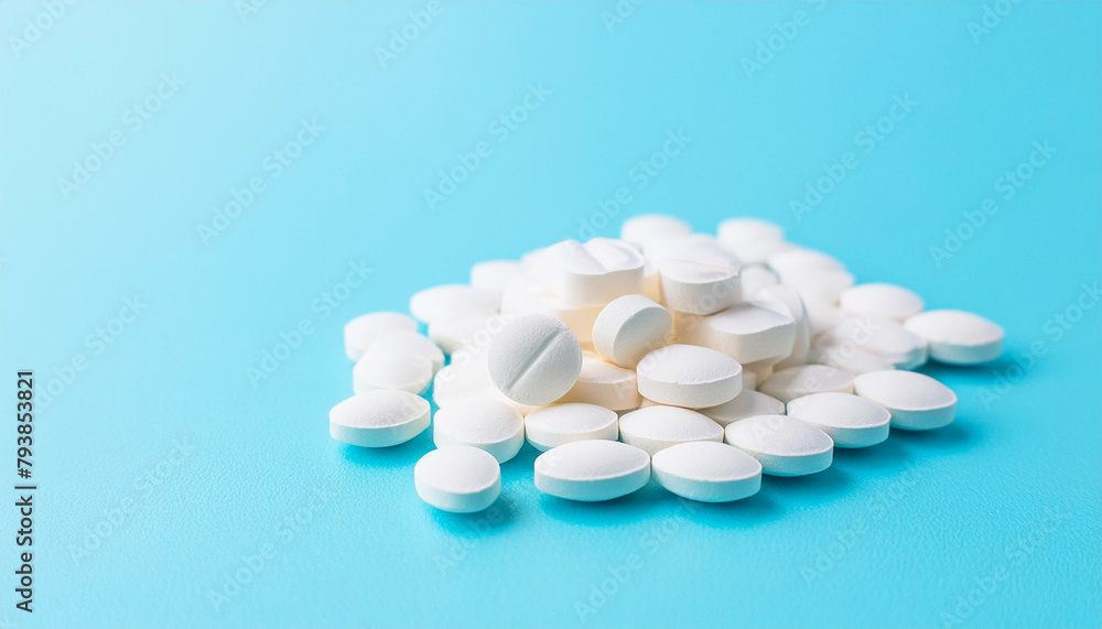 white pills on blue background white pills on blue background