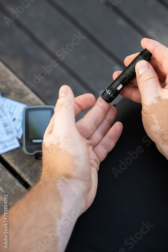 Men checking their sugar levels using a glucometer