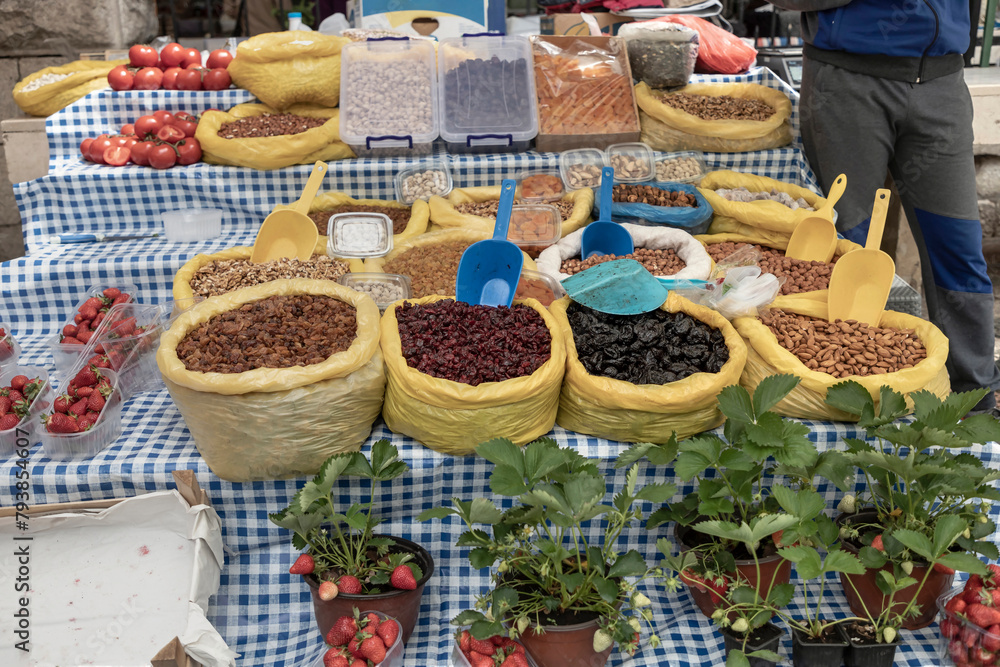 Kotor, Montenegro - Variety of strawberries, tomatoes, dried fruits and nuts displayed for sale at the local market stand