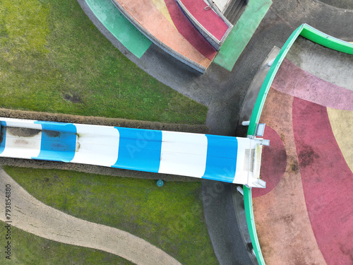 Aerial drone view children playground in the form of a puzzle piece. Colorfull recreation area with slide, swing and climbing racks at Maarsseveens Plassen , The Netherlands. Close up view.