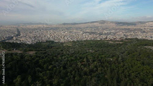 Drone aeial view of Athens city with Green nature Forest park in Acropolis in Greece, Parthenon in Athens drone aerial view, famous Greek tourist attraction photo