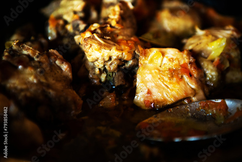 delicious homemade fried meat in a pan, closeup photo