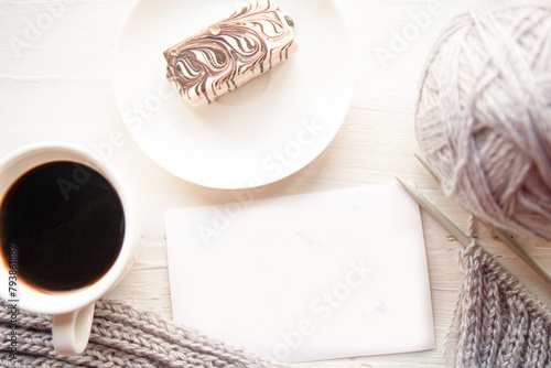 Coffee cup, cake and knitting on wooden background. Stay Home concept photo