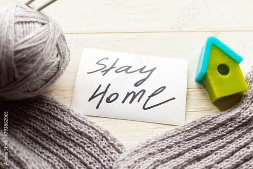 knitting and toy house on wooden background. Stay Home concept photo