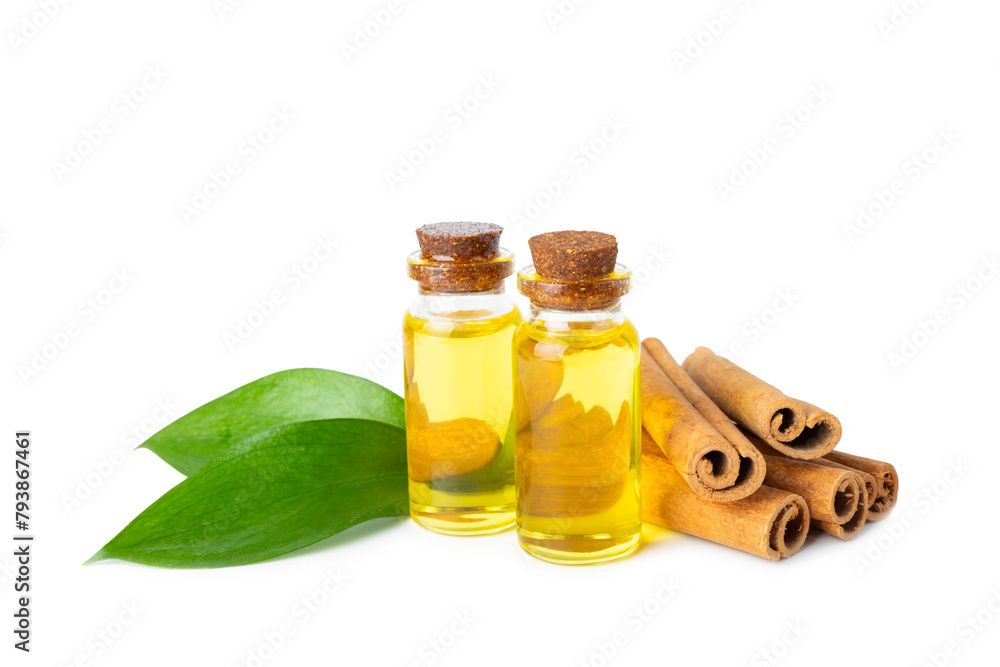 Cinnamon aromatic essential oil and cinnamon sticks isolated on white background. Aromatherapy. Organic cosmetic oil. Spa concept. Cinnamon aromatic essential oil and cinnamon sticks isolated on white background. Aromatherapy. Organic cosmetic oil. Spa concept.