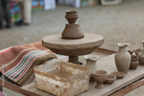 Making clay pot on the pottery wheel , Select focus, close-up, Pottery, hand work in Lok Virsa Pakistan
