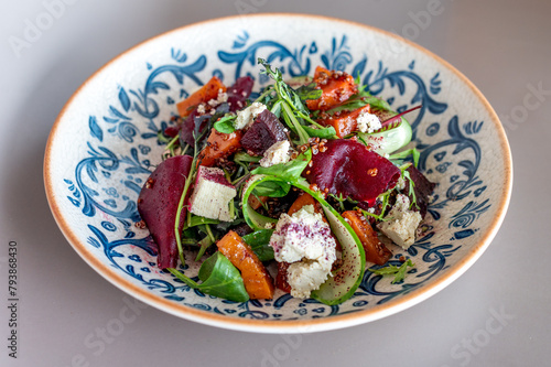Sumptuous beetroot salad, tangy feta, quinoa sprinkle, in a handcrafted blue-patterned bowl. Vibrant, healthy gastronomy with an artisanal touch. (ID: 793868430)
