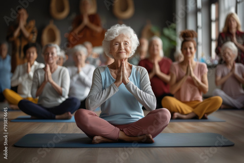 Elderly woman with a serene expression practicing yoga with a group