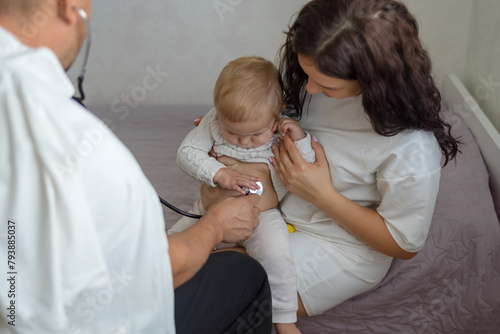 Pediatrician hold stethoscope exam baby. Children medical care