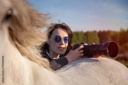 beautiful woman making pictures of horse