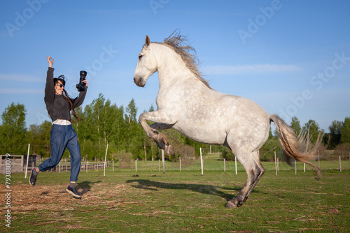 beautiful woman making pictures of horse