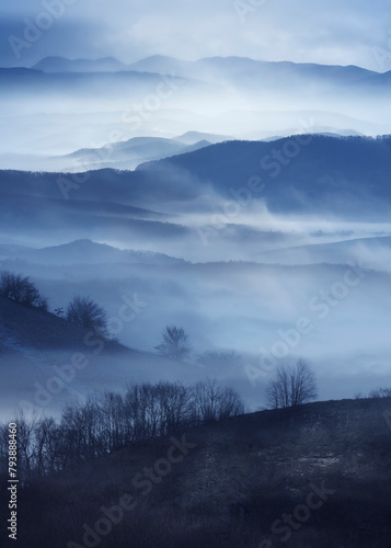 mountains and hills in fog, mysterious dark halloween landscape