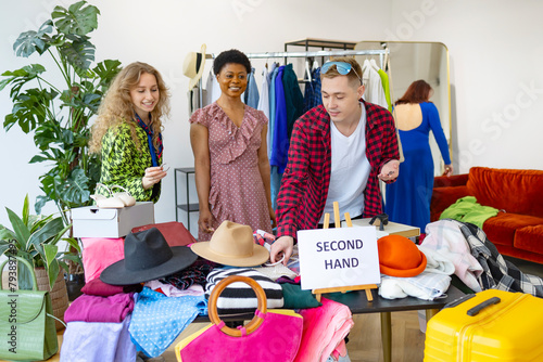 second-hand store, saving money and family budget, young people students at swap party try on clothes, bags, shoes and accessories, change clothes with each other, second hand for things, zero waste photo