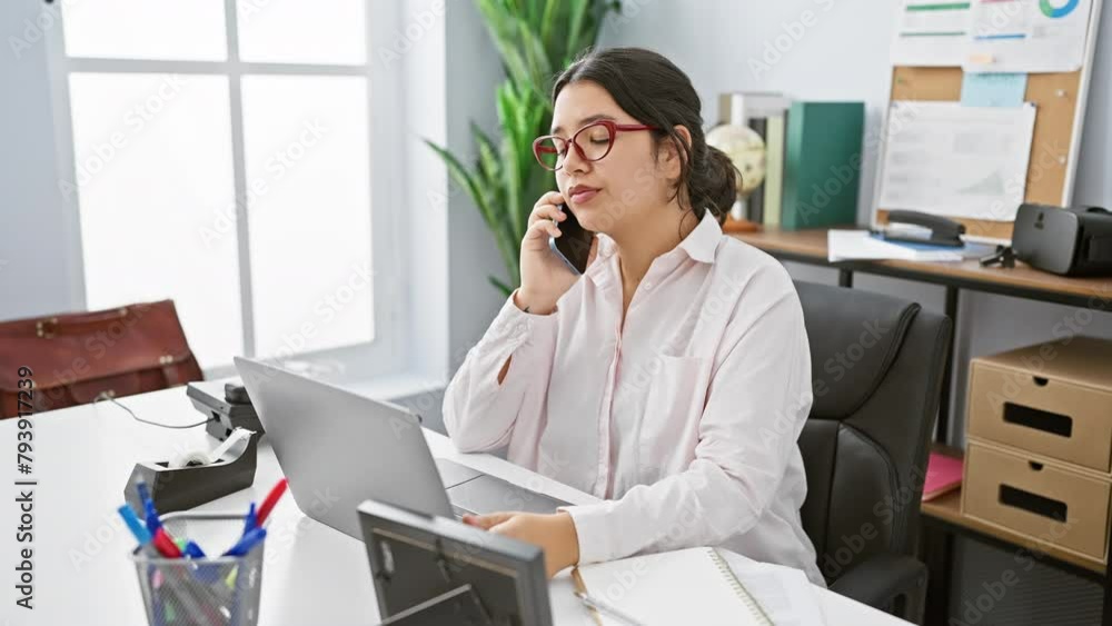 custom made wallpaper toronto digitalHispanic woman working in an office using a phone and a laptop with a window background