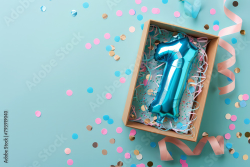 First birthday gift box with number 1 balloon inside, confetti and ribbons on a pastel background © ink drop