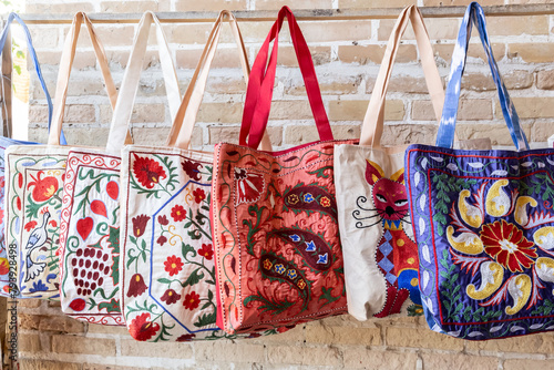 Colorful traditional Uzbek embroidered bags on display, ideal for souvenirs and cultural representation. Bukhara, Uzbekistan