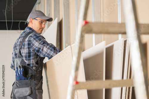Construction Site Worker Selecting Right Drywall Panels
