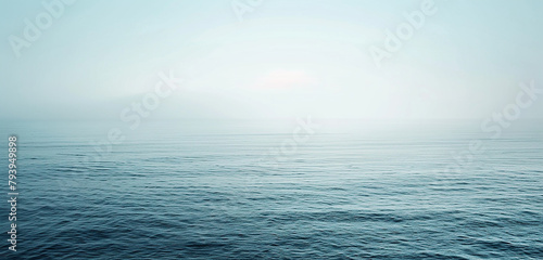 A panoramic view of a calm sea, the intensity of the ocean's blue gently faded near the horizon where it meets a pale, washed-out sky,32k, full ultra hd, high resolution