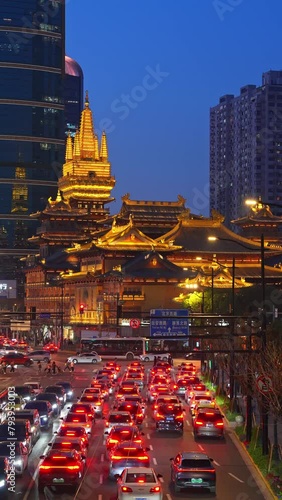 4K real time of Busy traffic road with JingAn temple. JingAn Temple is a Buddhist temple on the West Nanjing Road in Shanghai, China photo
