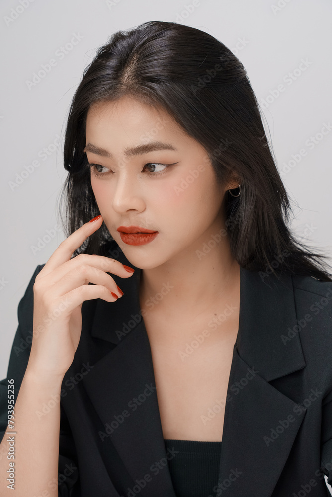 Gorgeous Young Asian female close up face with perfect make-up and red lips. Beautiful woman in black suits look confidence and charming. Gorgeous Young Asian female close up face with perfect make-up and red lips. Beautiful woman in black suits look confidence and charming.