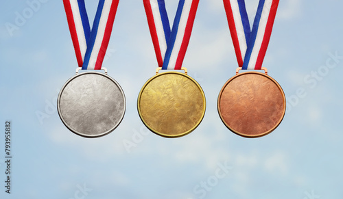 Collection of real gold medals isolated on blue sky background with a lot of text area - winner copy space concept