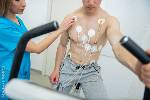 Medical professional conducting a cardiovascular evaluation with ecg electrodes photo
